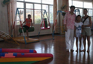 Our Daughters with the Orphanage Director in the Physical Therapy Room.