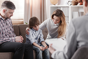 Parents and Young boy with Therapist